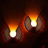 Decorative hanging lights with intricate designs on a dark background